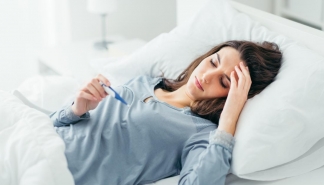 woman in bed with fever